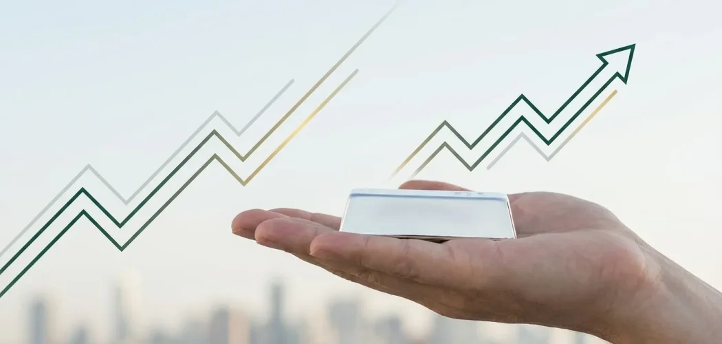 Gold Price Trader: Hand holding a silver bar with upward trend lines, symbolizing silver's long-term investment growth.